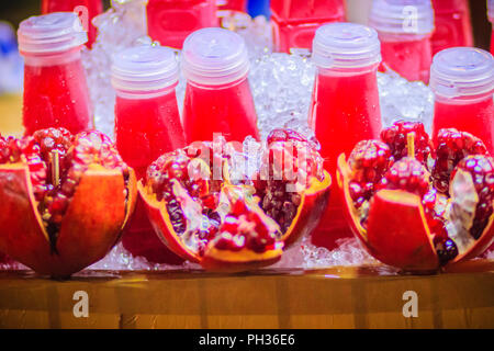 Rosso il succo di melograno e freschi frutti di melograno che pronto da bere per la vendita su strada a Bangkok il mercato notturno, Thailandia. Foto Stock