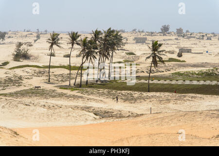 KAYAR, SENEGAL - Apr 27, 2017: Non identificato ragazzo senegalese sorge sul campo con le palme in un bel villaggio vicino Kayar, Senegal Foto Stock