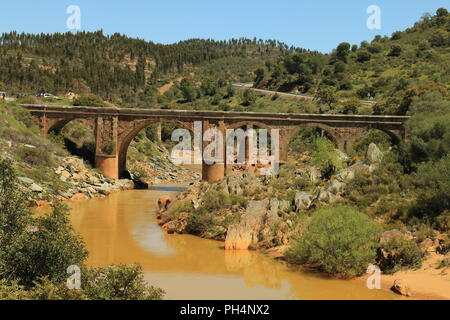 Il vecchio ponte di pietra sul fiume Odiel, sul percorso dei mulini, ideale per fare escursioni nella provincia di Huelva, Spagna Foto Stock