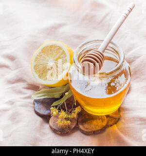 Tè con Linden, miele e limone. Il vassoio sul letto, il concetto di trattamento di raffreddori. Foto Stock