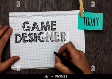 La grafia la scrittura di testo Game Designer. Concetto significato i diruttori Pixel ai programmatori di scripting di console grafica 3D notebook aperto clothespin tenendo premuto r Foto Stock