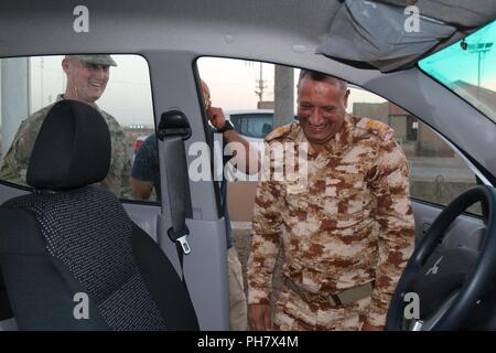 Lt. Col. Thomas Turner è al fianco delle forze di sicurezza irachene in ambra Sicurezza di Zona comandante come egli ha viste di un veicolo durante un acquisto di veicoli per il comando di guarnigione a Taji complesso militare in Iraq. Combined Joint Task Force - Funzionamento inerenti risolvere è una coalizione di 21 nazioni e cinque organizzazioni che si sono impegnati a raggiungere l'obiettivo di eliminare la minaccia rappresentata da ISIS in Iraq e Siria e hanno contribuito in vari modi per lo sforzo. Foto Stock