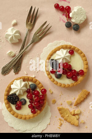 Piccolo tartlet con panna alla vaniglia Bacche e meringa Foto Stock