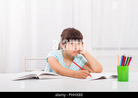 Bambina deve rimanere a casa e fare il suo dovere,ma avrebbe invece giocare all'esterno. Foto Stock