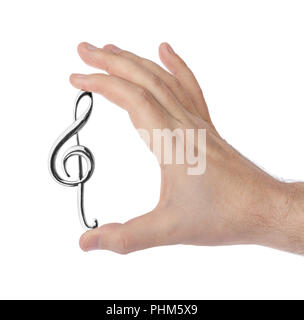 Mano che tiene una chiave di violino Foto Stock