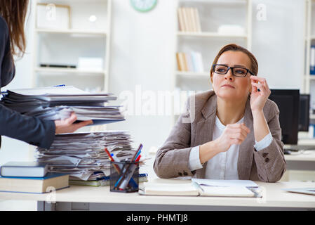 Imprenditrice molto occupato con documenti in corso Foto Stock