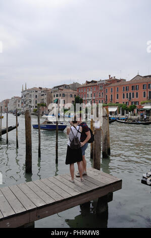 Due giovani turisti per vedere i siti sul Canal Grande a Venezia Foto Stock