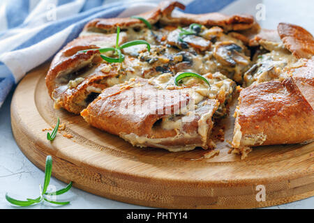 Galette con funghi e formaggio tagliato a pezzi. Foto Stock