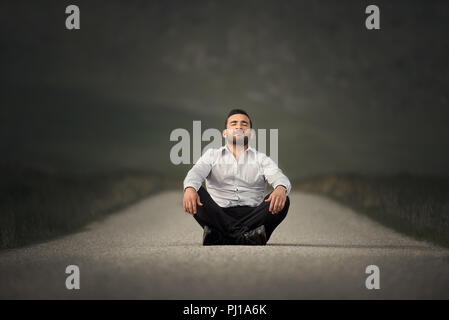 Ritratto di un uomo seduto al centro di un percorso meditato, Irlanda Foto Stock