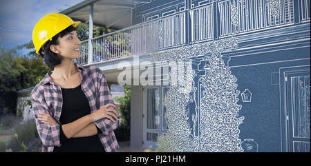 Immagine composita di architetto femmina in piedi con le braccia incrociate contro uno sfondo bianco Foto Stock