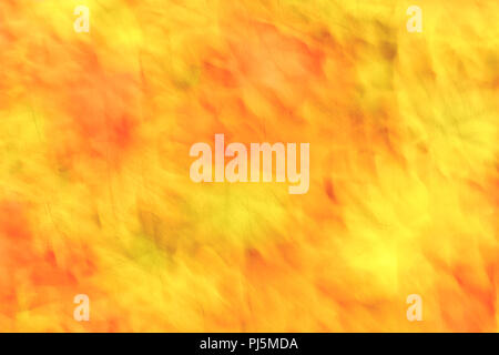 Abstract motion blur con colorati vibrante cadono le foglie in arancione, giallo e verde. Foto Stock