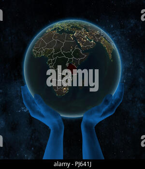 In Tanzania la notte sul pianeta Terra con visibili i confini del paese in mani nello spazio. 3D'illustrazione. Foto Stock