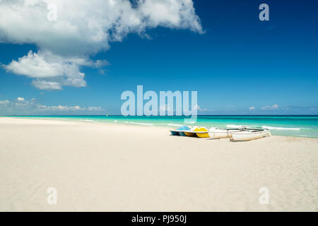 Bellissima spiaggia di Varadero durante una giornata di sole, sabbia fine e bianca e turchese e verde mare dei Caraibi, a destra in catamarano e piccole imbarcazioni per i tour Foto Stock