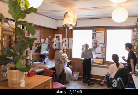 Il creativo con il cane il brainstorming in office Foto Stock