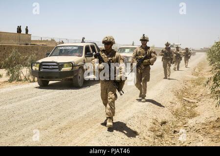 Provincia di Nimroz, Afghanistan (Luglio 8, 2018) - USA Marines con la Task Force a sud-ovest e soldati con la quarta brigata, Esercito nazionale afgano 215th Corps escort governatori distrettuali ad una sicurezza shura durante un expeditionary pacchetto consultivo a inoltrare una base operativa (FOB) Delaram. Stati Uniti Marines speso circa una settimana a Delaram FOB per condurre riunioni di sicurezza con i principali leader dalla provincia di Nimroz e a sviluppare un rapporto e consigliare il loro nazionale afghano di difesa e le forze di sicurezza delle controparti. Foto Stock