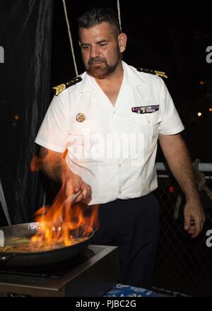 PEARL HARBOR (Luglio 3, 2018) un marinaio francese rende crepes durante la ricezione francese a bordo della marina francese frigate Prairial FS (F731), durante RIMPAC 2018, 3 luglio. Venticinque nazioni, 46 navi, cinque sommergibili, circa 200 aerei, e 25.000 personale partecipano RIMPAC dal 27 giugno al 2 agosto in e intorno alle Isole Hawaii e la California del Sud. Il più grande del mondo marittimo internazionale esercitazione RIMPAC offre una singolare opportunità di formazione promuovendo e sostenendo le relazioni cooperative tra i partecipanti sono fondamentali per garantire la sicurezza dei corridoi di traffico e di sicurezza della Foto Stock