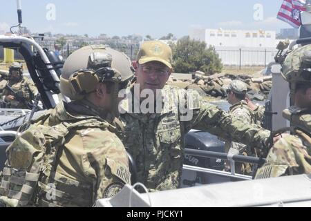 SAN DIEGO (Luglio 24, 2018) DEGLI STATI UNITI Navy Adm posteriore. Dave Welch, commander, combinata Task Force (CTF) 177 e la superficie navale e il mio combattimento Centro di sviluppo (SMWDC), centro, parla con gli Stati Uniti Costa guardie attaccata alla USCG Maritime Security Response Team West (MSRT-W) durante una visita negli Stati Uniti. Coast Guard Settore San Diego come una parte del bordo del Pacifico (RIMPAC) esercizio nella California meridionale area di operazioni, 24 luglio. Venticinque nazioni, 46 navi, cinque sommergibili e circa 200 aerei e 25.000 personale partecipano RIMPAC dal 27 giugno al 2 agosto in ed intorno a l'Hawaiian è Foto Stock