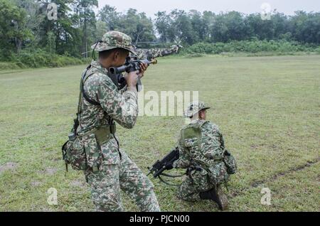 Soldati con il quindicesimo Royal Reggimento Malay, fissare un perimetro durante i movimenti nella giungla durante l'esercizio Keris sciopero, luglio 24, 2018, il Camp Senawang, Malaysia. Soldati malese sono state dimostrando la loro tattica di giungla in preparazione per sciopero Keris giungla della formazione sul campo di esercizio. Foto Stock