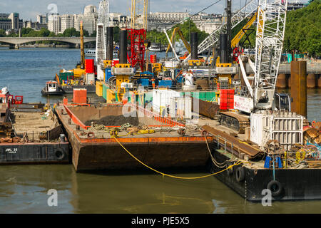 La Thames Tideway sotto regime di costruzione con macchinari pesanti su chiatte sul fiume, London, Regno Unito Foto Stock