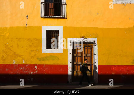 Rosso brillante e parete gialla nella luce del mattino, Puebla, Messico Foto Stock