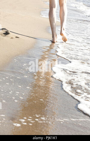 Gli uomini per le gambe sulla spiaggia sabbiosa Foto Stock