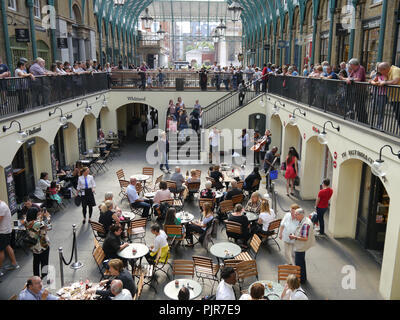 Diners ascoltare una string trio in Covent Garden di Londra, Inghilterra Foto Stock