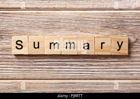 Sommario parola scritta sul blocco di legno. Il testo di riepilogo sulla tabella, concetto. Foto Stock