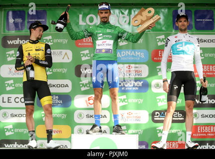 Del team Quick Step piani Julian Alaphilippe celebra vincendo l'Ovo Energy Tour della Gran Bretagna 2018, accanto al secondo posto di Team Sky della Wout Poels (a destra) e al terzo posto il Team Lotto NL-Jumbo di Primoz Roglic. Foto Stock