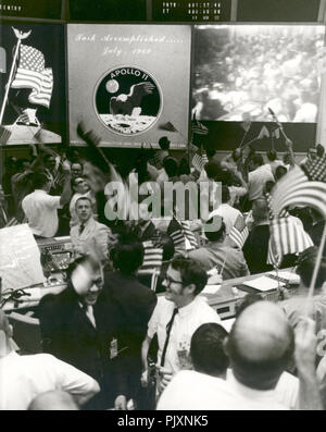 Houston, TX - (file) -- vista complessiva della missione di controllo delle operazioni in camera il Mission Control Center, edificio 30, presidiata centro di veicolo spaziale, mostrando i controllori di volo per celebrare la conclusione positiva dell'Apollo 11 atterraggio lunare missione sulla luglio 24, 1969. Credito: la NASA via CNP /MediaPunch Foto Stock