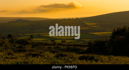 Sole serale in inglese del paesaggio rurale con i campi e le aziende agricole Foto Stock