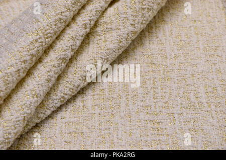 Tessuto in lana con acrilici e lurex, avorio con oro Foto Stock