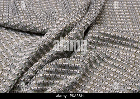 Tessuto in lana con acrilici e lurex, grigio con oro Foto Stock