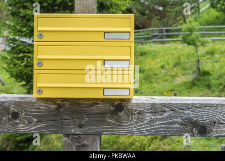 Letterbox giallo di stagno senza nome in una zona rurale, Austria Foto Stock