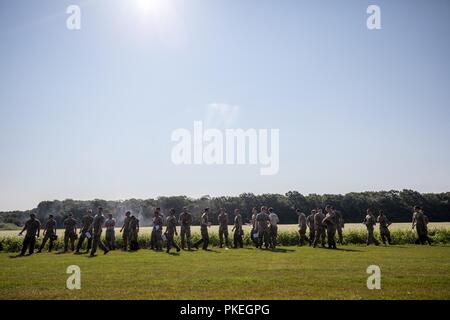 Stati Uniti I soldati dell esercito di attendere per i paracadutisti di sbarcare sul Castello zona di caduta al fine di contare i loro tempi di punteggio e le loro squadre durante Leapfest presso la University of Rhode Island, West Kingston, R.I., e il Agosto 5, 2018. Leapfest è il più grande e il più lungo in piedi, international static line parachute evento di formazione e competizione ospitata dalla 56th squadrone comando, Rhode Island esercito Guardia Nazionale per promuovere tecniche di alto livello e esprit de corps entro il International Airborne comunità. Foto Stock