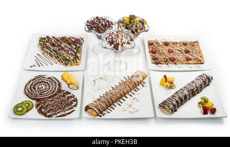Set di Crepes e frittelle decorate con frutta e gelato isolati su sfondo bianco, percorso di clipping incluso Foto Stock