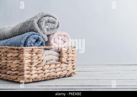 Cestino in vimini con asciugamani piegati su tavolo in marmo bianco in bagno  Foto stock - Alamy