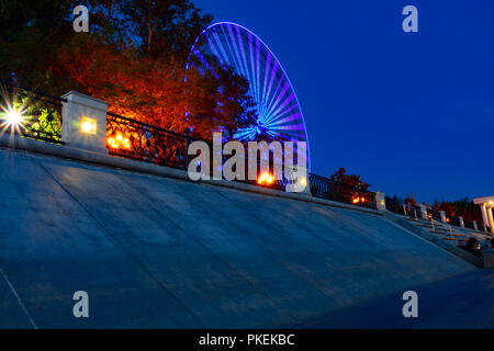 Ruota panoramica sulle rive del fiume Amur a Khabarovsk contro il cielo di notte. Un brillante illuminazione. Fotografato a lunga esposizione. Foto Stock