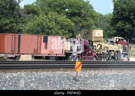 Trattore Semi-rimorchi caricati con attrezzature militari sono schierati il Agosto 1, 2018 su una strada a sud di Post in attesa di essere scaricati a Fort McCoy, Wis. attrezzature è stata spedita in per uso nella formazione 86a Divisione di combattere la formazione per il supporto di esercizio (CSTX) 86-18-02. Migliaia di truppe partecipare all'esercizio e centinaia di pezzi di equipaggiamento sono stati consegnati per quelle truppe per l'uso. Questa è la seconda CSTX ospitato dal 86º nel 2018 e la terza CSTX presso l'installazione di quest'anno. Foto Stock