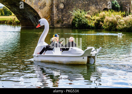 Per coloro che godono di un rilassante viaggio di ritorno su un cigno pedalò a forma di barca sul fiume Tamigi a Lechlade-on-Thames, al confine con il Costwolds. Gloucestershire, Regno Unito. Foto Stock