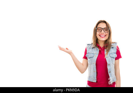 Sorridente giovane donna adolescente in occhiali tenendo la mano con il palmo rivolto verso l'alto facendo presentazione isolata su sfondo bianco Foto Stock