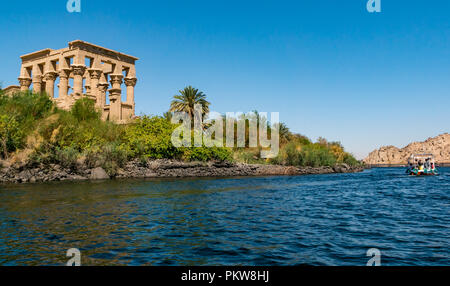 I turisti in barca lasciando il Tempio di Philae con Kioske di Phylae, Agilkia Island, il lago Nasser, Fiume Nilo, Aswan, Egitto, Africa Foto Stock