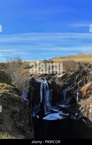 Regno Unito, Cumbria, Coniston. Vista verso la cascata ghiacciata dalla cava Banishead Torver comune nel Lake District inglese. Foto Stock