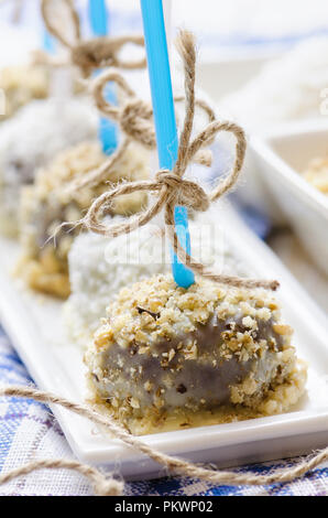 Cakepops al cioccolato con noci e scaglie di cocco. Close up. Foto Stock