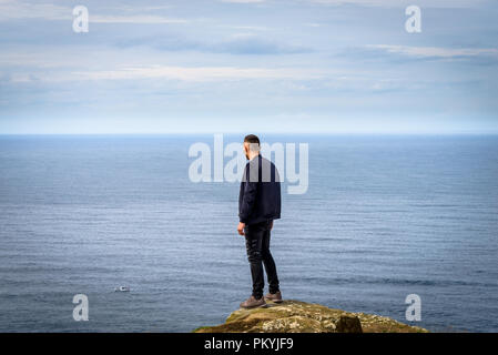 Uomo in piedi sulla scogliera Foto Stock