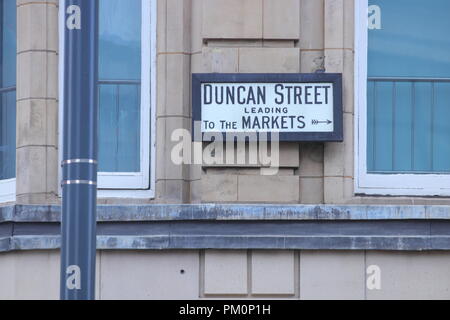 Il nome di una strada segno con le indicazioni per i mercati a Leeds. Foto Stock