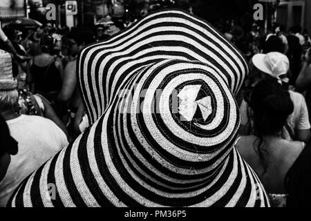 Hat con strisce nere e la folla in una strada festa di carnevale in background. Foto Stock