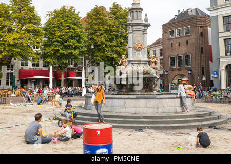 Bambini che giocano con la sabbia e acqua a sandbox improvvisata all interno della città Fontana di Deventer, Paesi Bassi Foto Stock