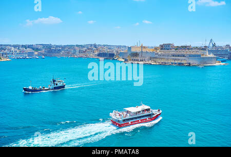 La Valletta, Malta - 17 giugno 2018: l'imbarcazione da diporto con turisti fa un viaggio lungo la Valletta Grand Harbour con vista su San Angelo forte sulla BAC Foto Stock