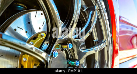 Lucidati mag ruota con vite blu cappelli di un automobile Foto Stock