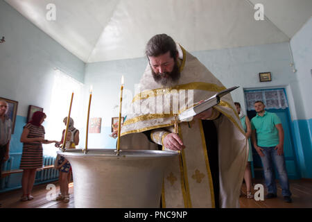 La Bielorussia, Gomel, il 14 luglio 2018. Il sacerdote si prepara per il rito del battesimo Foto Stock